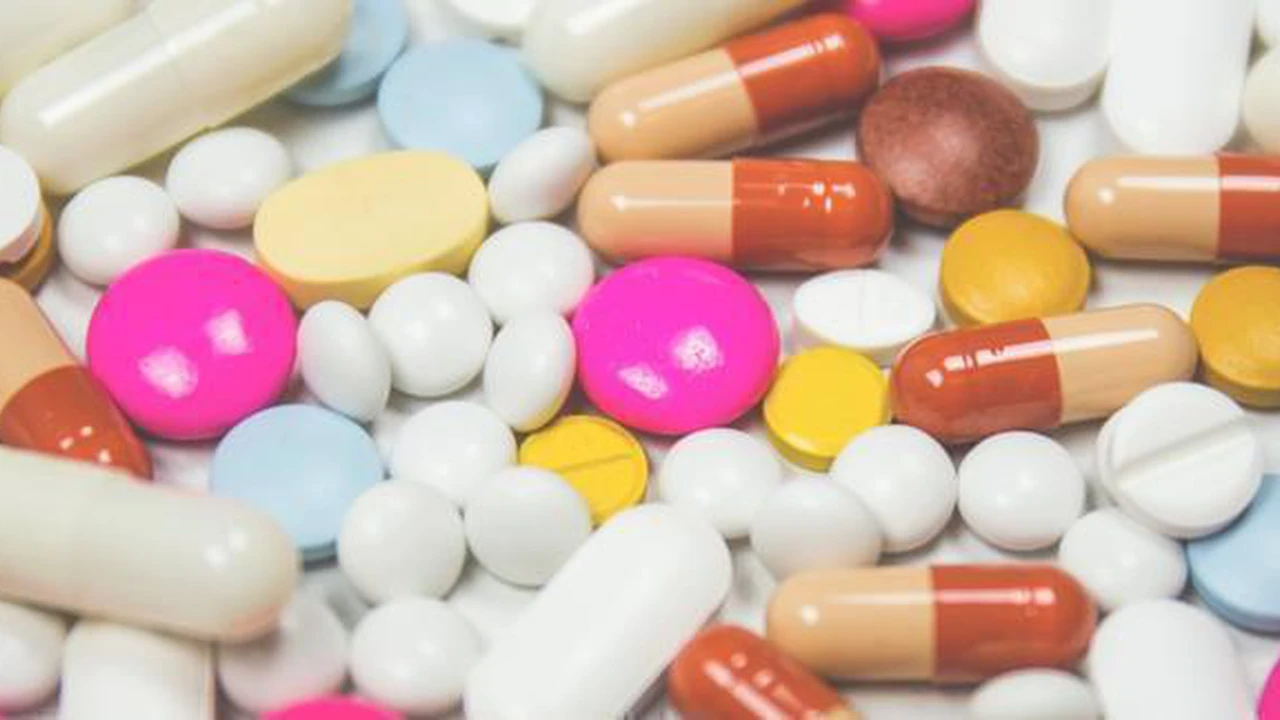 Close up on a plate of mashed potatoes, topped with baked pork chops with cream of mushroom soup, and a side of green beans.