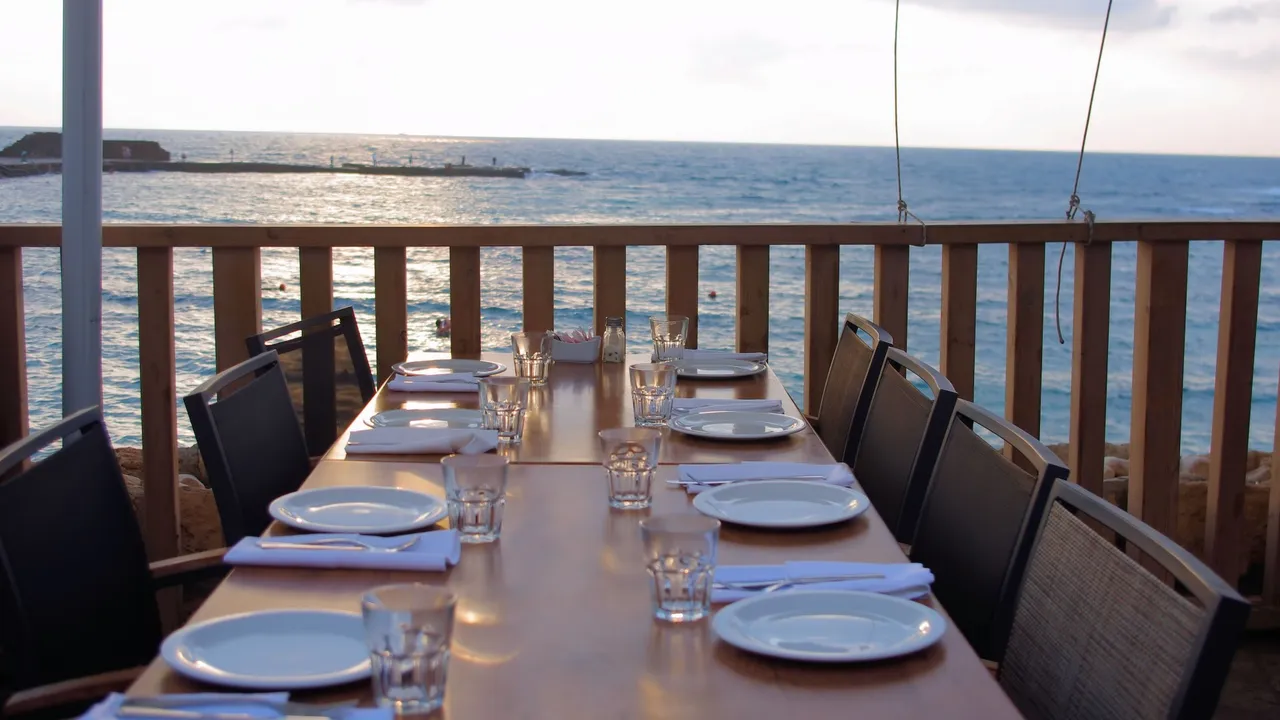 Close up on a plate of mashed potatoes, topped with baked pork chops with cream of mushroom soup, and a side of green beans.