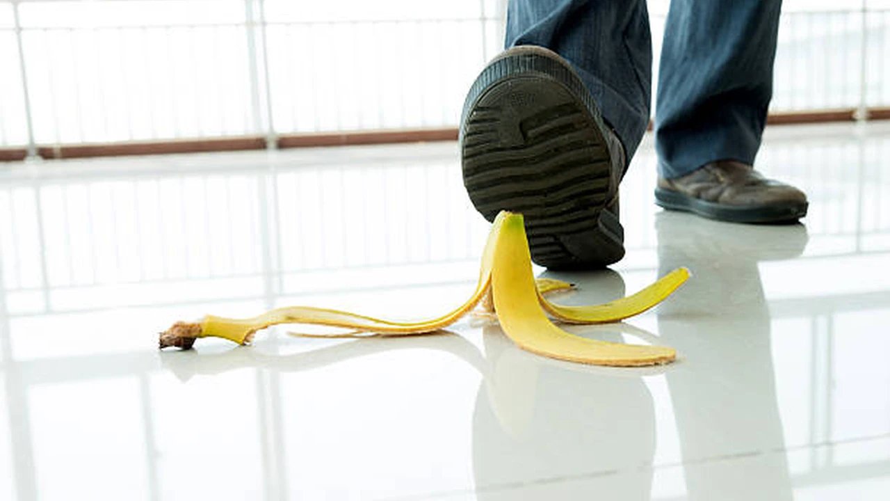 Close up on a plate of mashed potatoes, topped with baked pork chops with cream of mushroom soup, and a side of green beans.