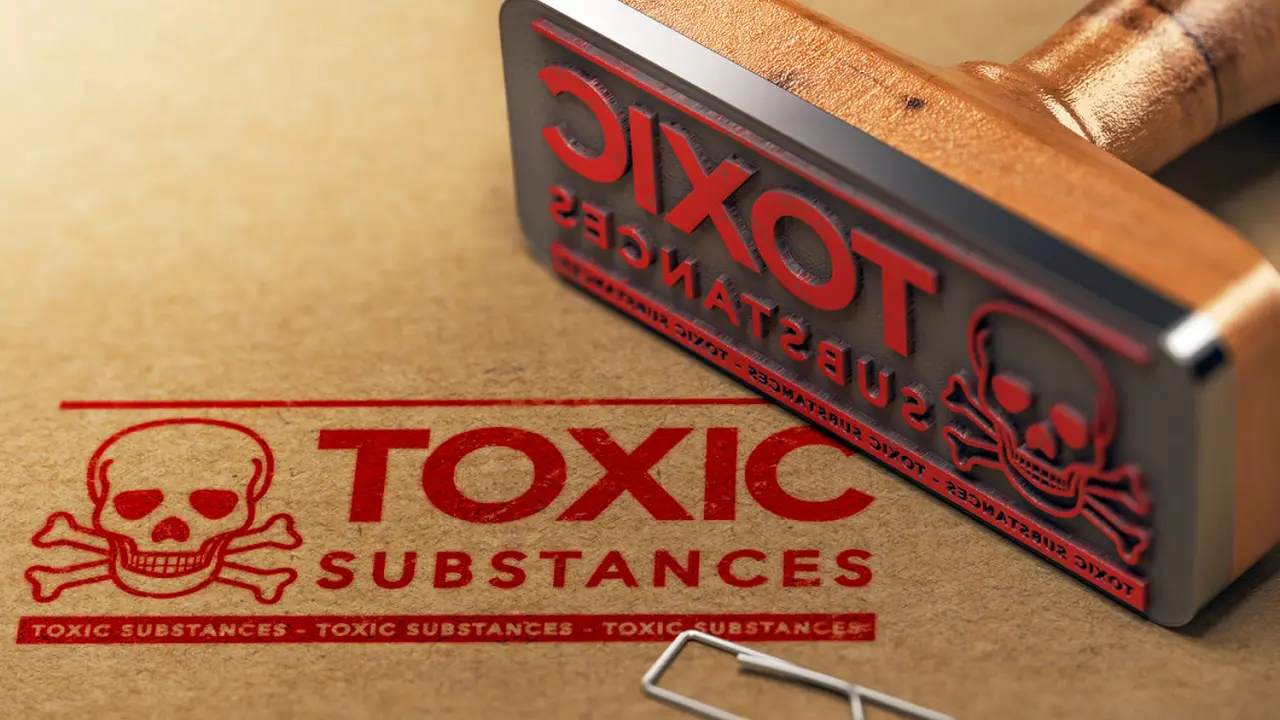 Close up on a plate of mashed potatoes, topped with baked pork chops with cream of mushroom soup, and a side of green beans.