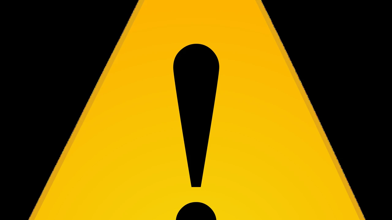 Close up on a plate of mashed potatoes, topped with baked pork chops with cream of mushroom soup, and a side of green beans.