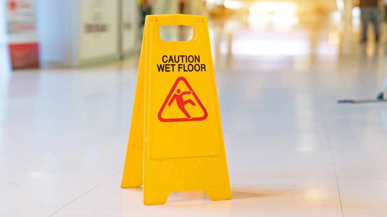 Close up on a plate of mashed potatoes, topped with baked pork chops with cream of mushroom soup, and a side of green beans.